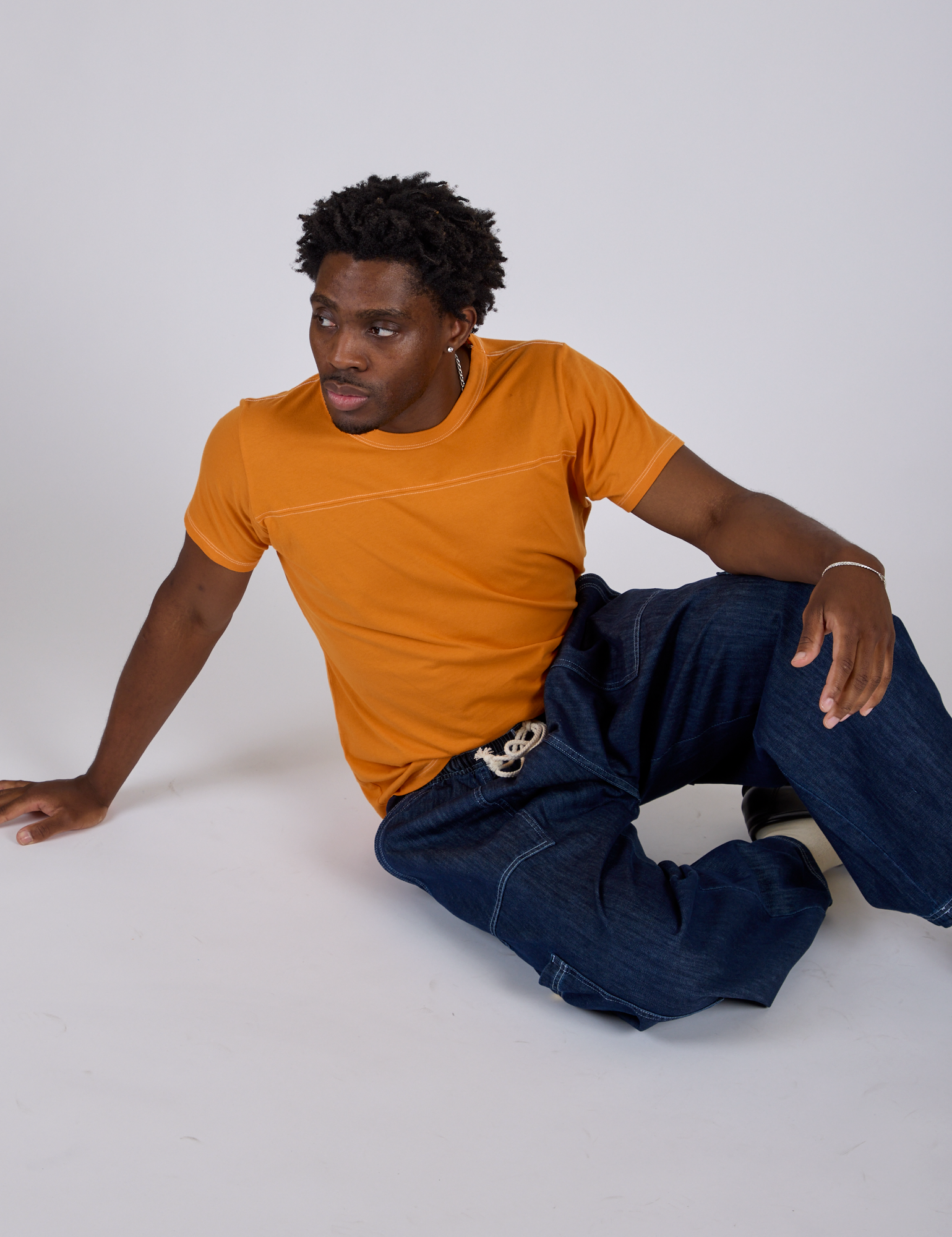 Jr. Varsity Tee in Creamsicle Orange and dark wash Denim Drop Pocket Pants worn by Isaac