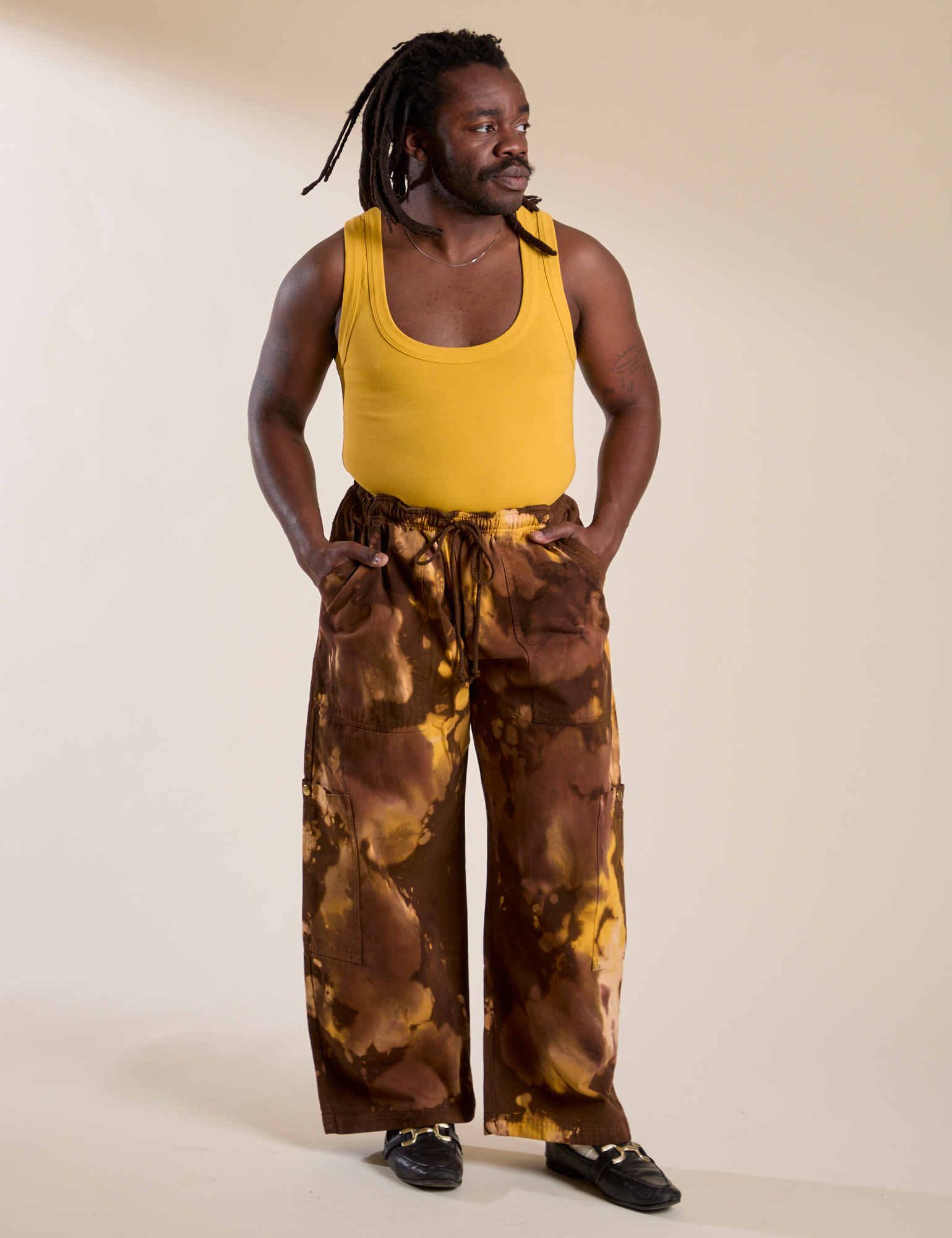 Demi is 5'6" and wearing S Magic Waters Drop Pocket Pants in Honey Brown paired with mustard yellow Cropped Tank