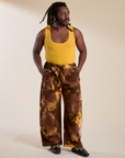Demi is 5'6" and wearing S Magic Waters Drop Pocket Pants in Honey Brown paired with mustard yellow Cropped Tank