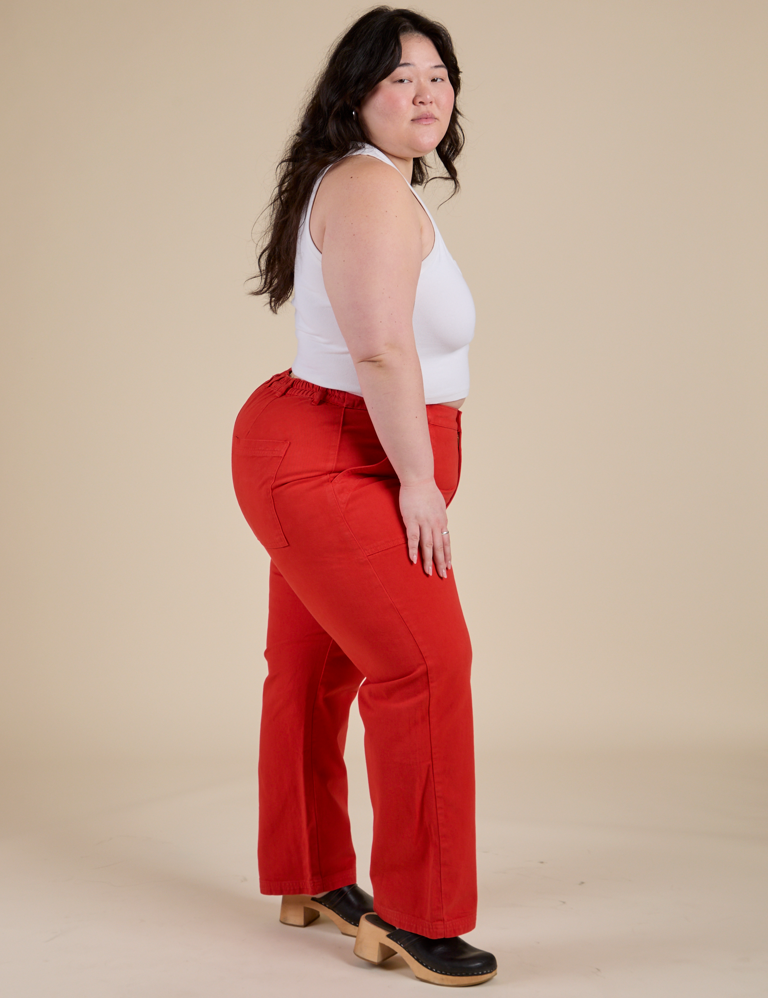 Side view of Work Pants in Mustang Red and Cropped Tank in Vintage Tee White on Ashley