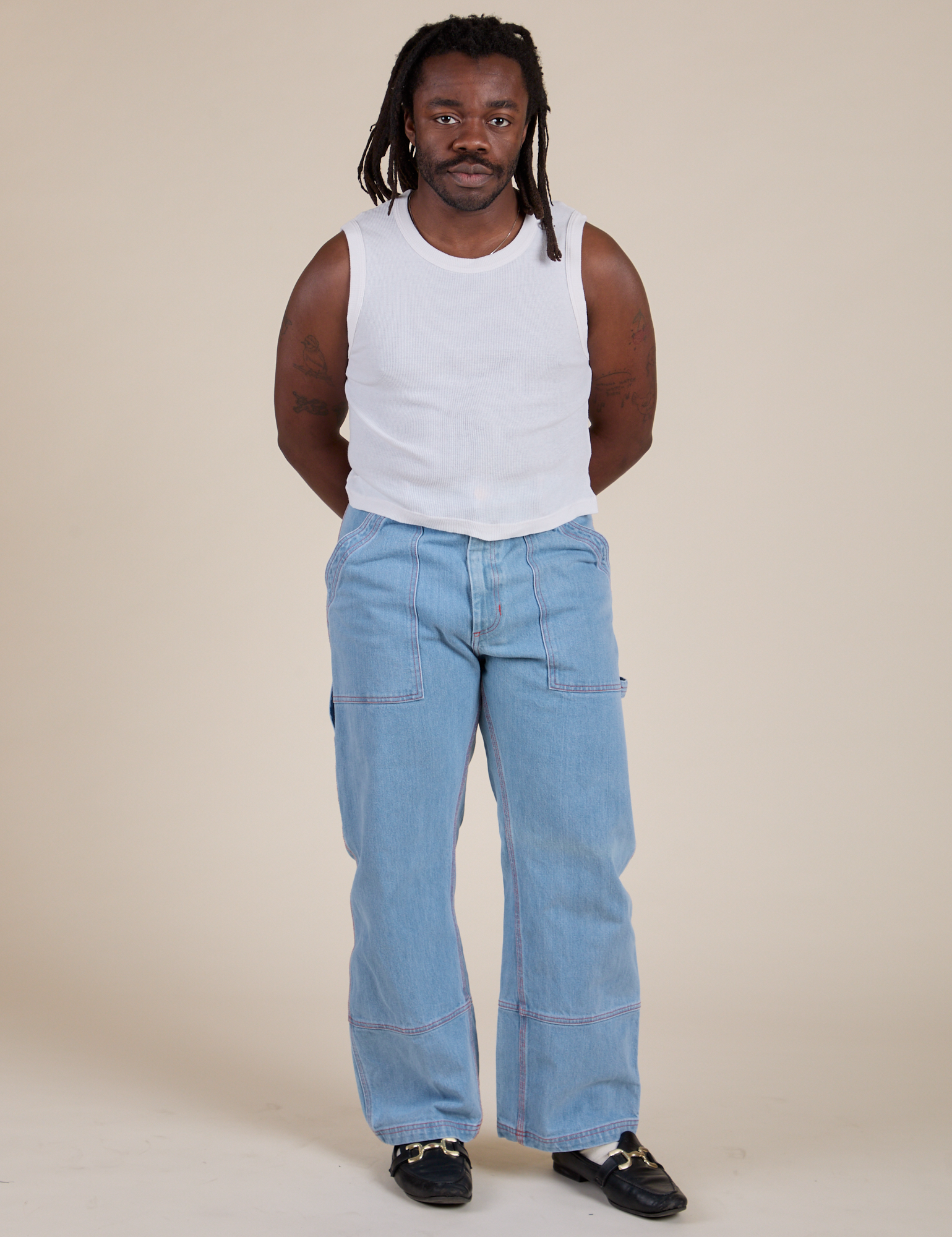 Muscle Tee in Vintage Tee White and light wash Carpenter Jeans on Demi
