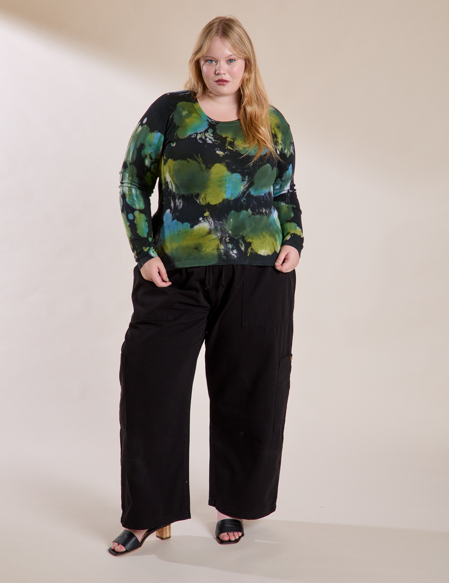 Juliet is wearing Long Sleeve Baby Tee in Green Pool paired with Drop Pocket Cargo Pants in Black