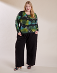 Juliet is wearing Long Sleeve Baby Tee in Green Pool paired with Drop Pocket Cargo Pants in Black
