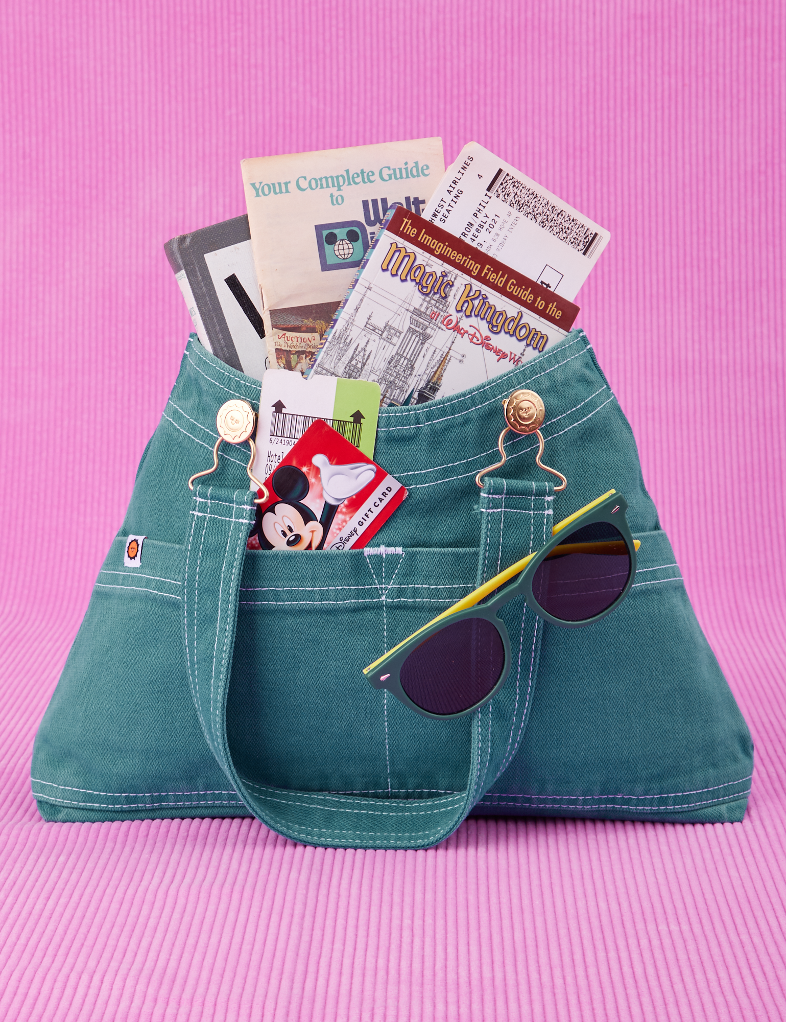 Overall Handbag in Marine Blue. Magic Kingdom brochures inside main compartment