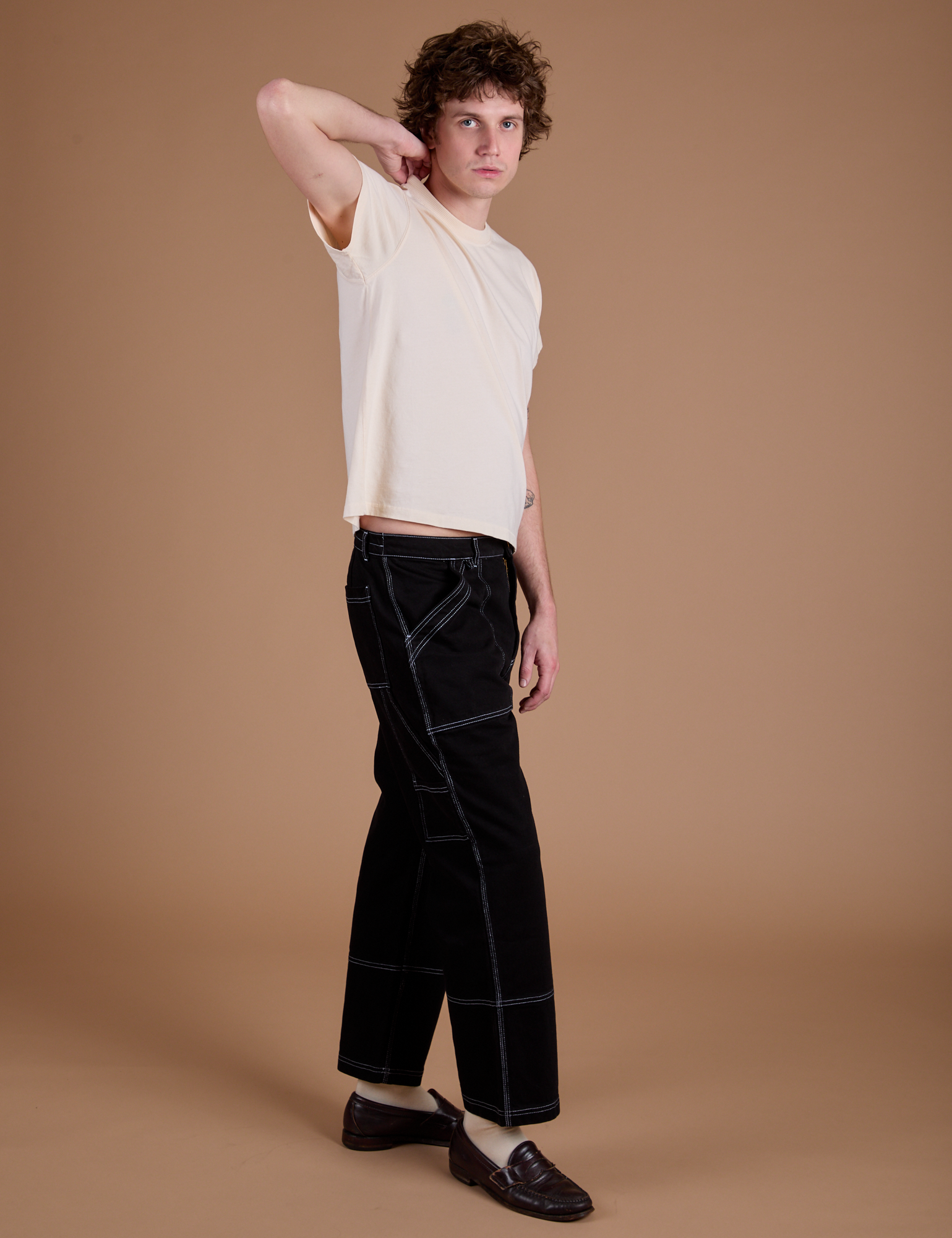 Carpenter Jeans in Black and the Organic Vintage Tee in Vintage Tee Off-White side view on Quinn