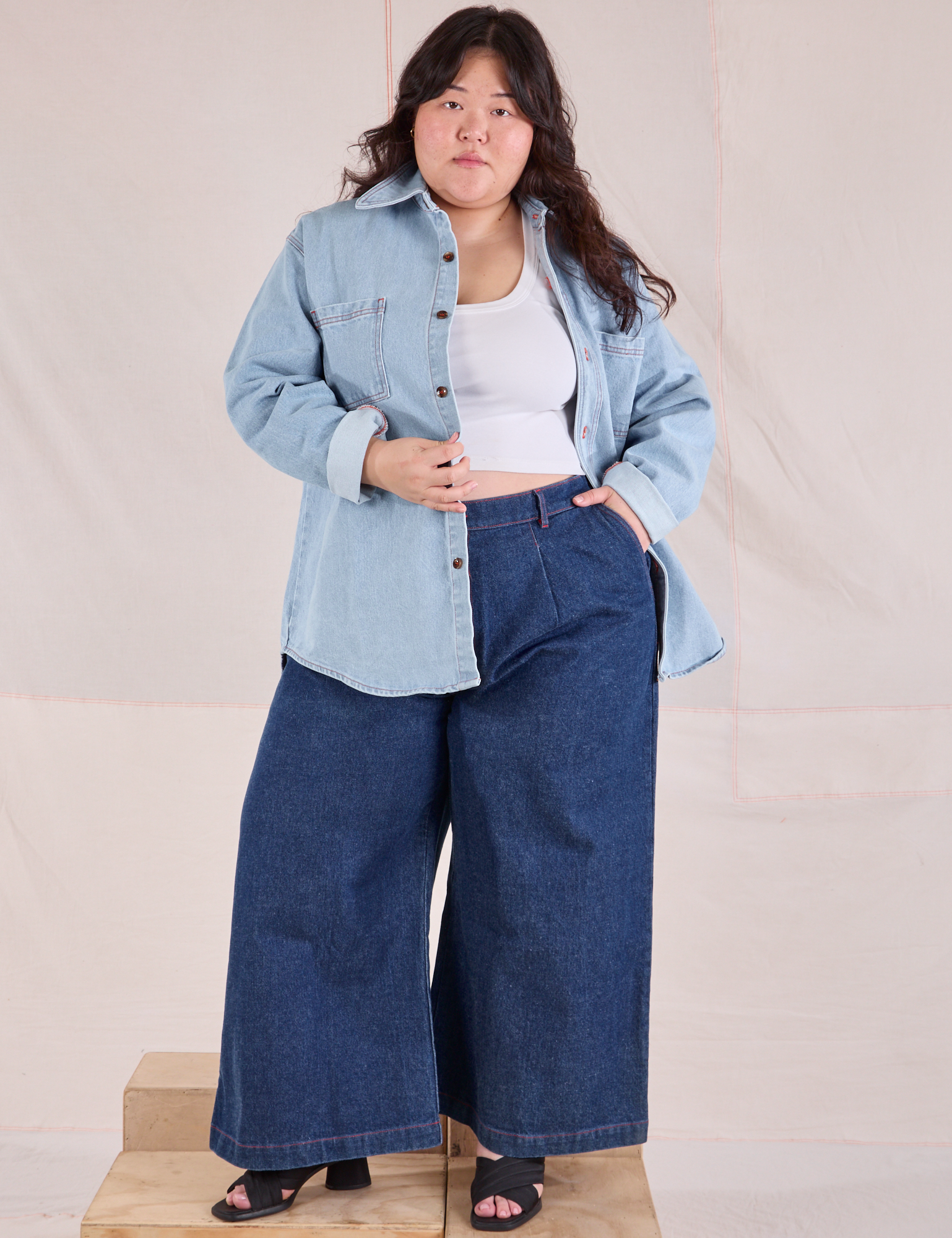 Ashley is wearing Denim Overshirt in Light Wash and dark wash Wide Leg Trousers