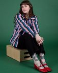 Sydney is wearing  Stripe Work Jacket in Pacific Stripe and Work Pants in black