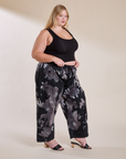 Angled front view of Magic Waters Drop Pocket Pants in Ink Blot and black Cropped Tank on Juliet