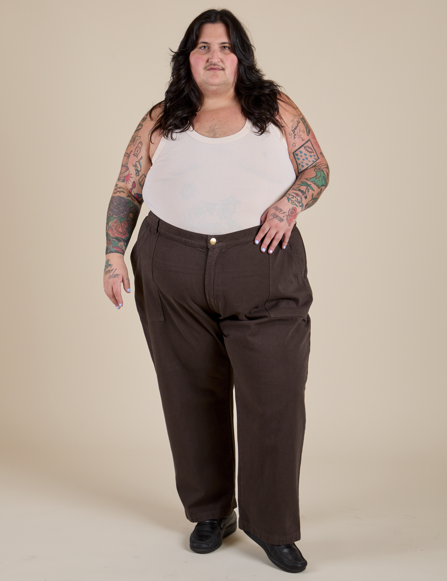 Sam is wearing Work Pants in Espresso Brown and vintage tee off-white Tank Top