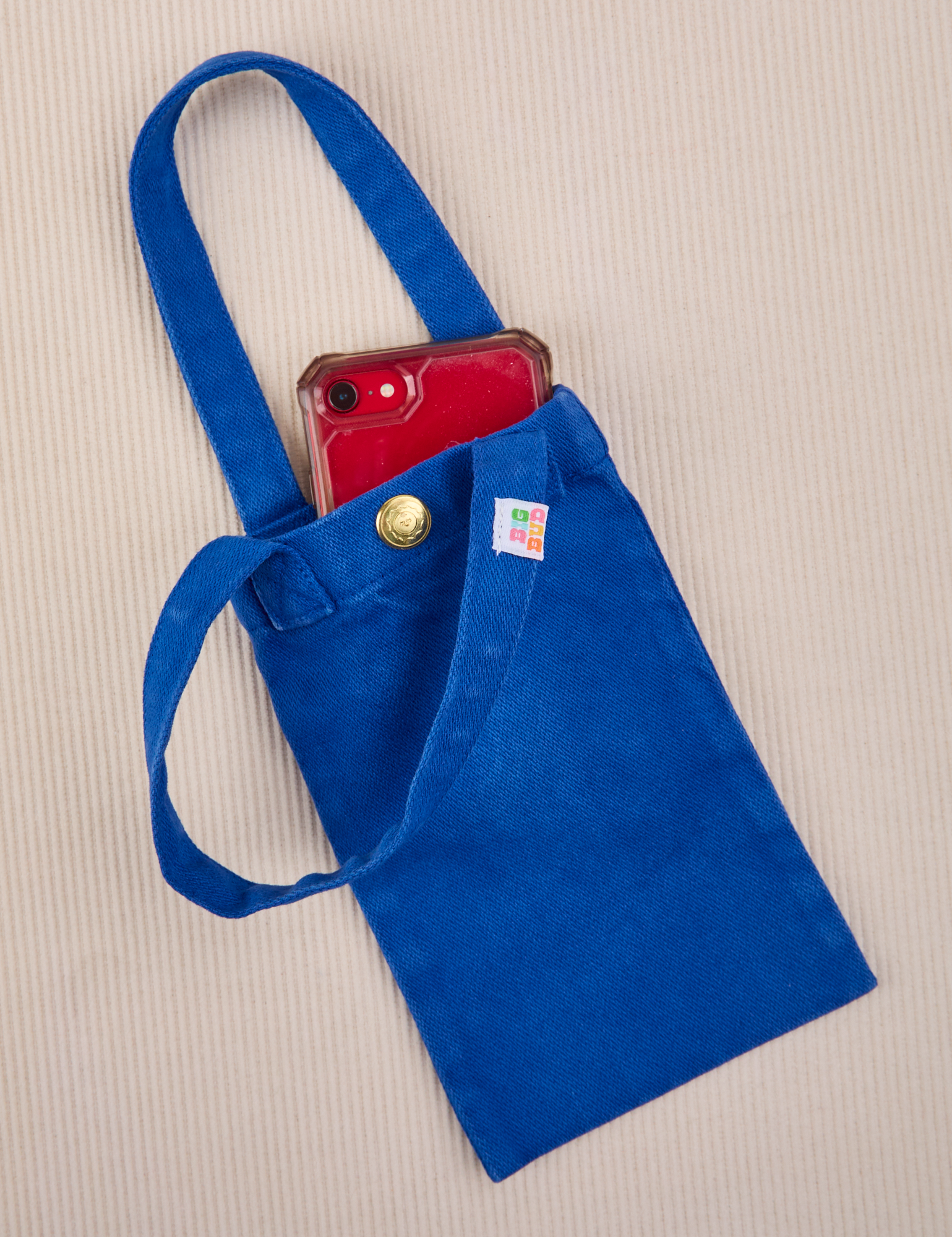 Phone tucked into royal blue Cell Phone Tote