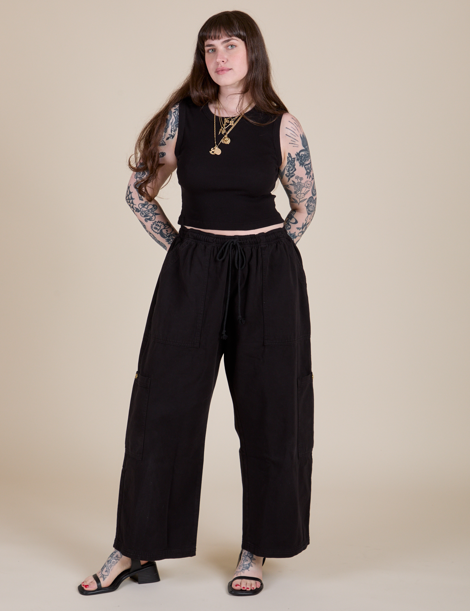 Sydney is wearing Muscle Tee in Basic Black and black Drop Pocket Cargo Pants