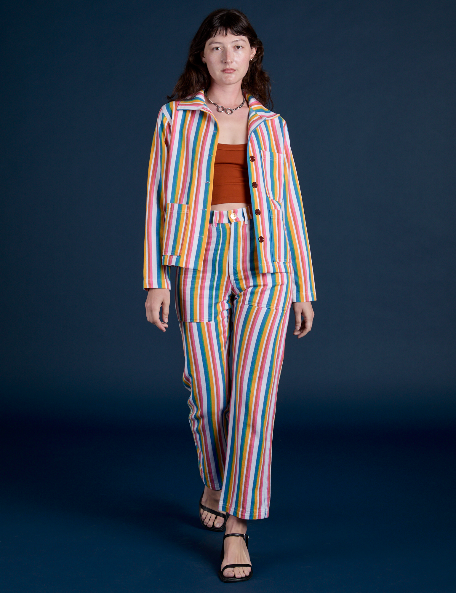 Alex is wearing  Stripe Work Jacket in Rainbow Stripe and matching Work Pants