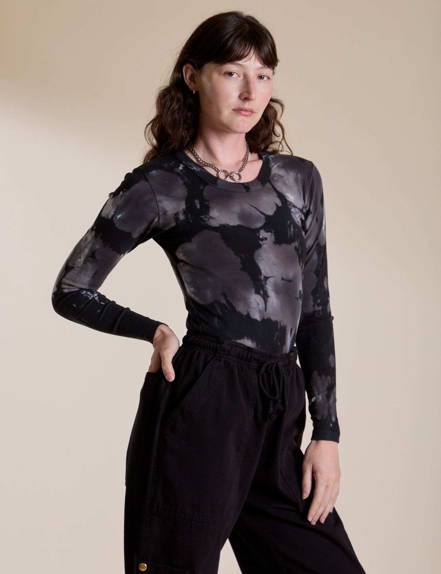 Long Sleeve Baby Tee in Ink Blot angled front view on Alex