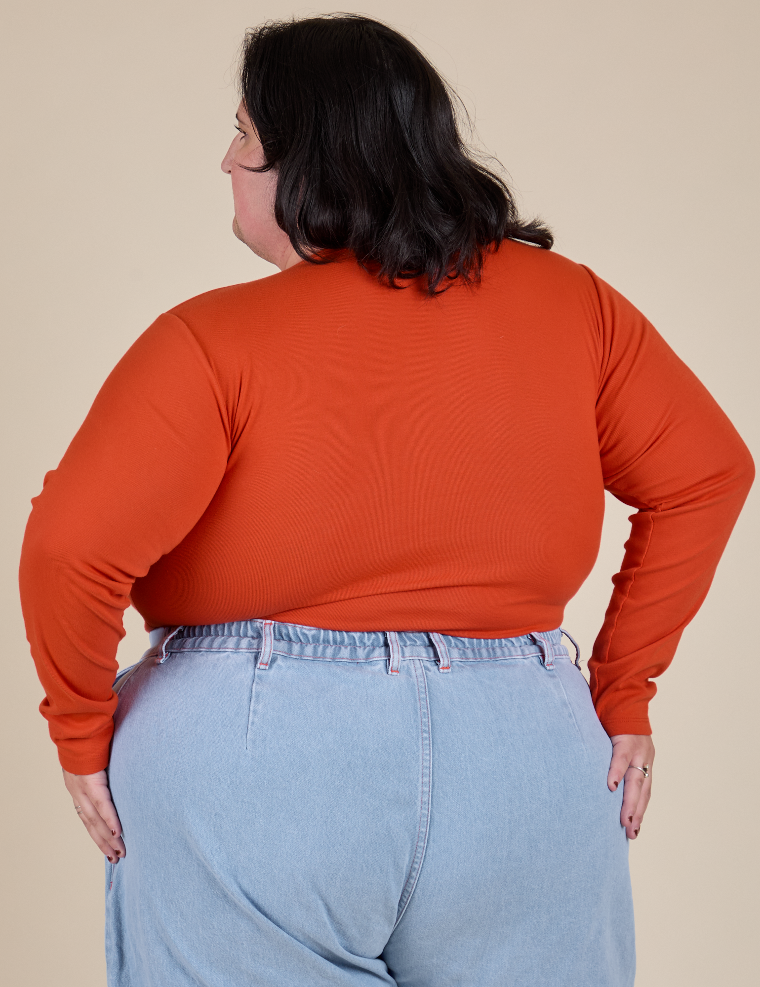 Long Sleeve Baby Tee in Chili Red back view on Sam