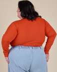 Long Sleeve Baby Tee in Chili Red back view on Sam