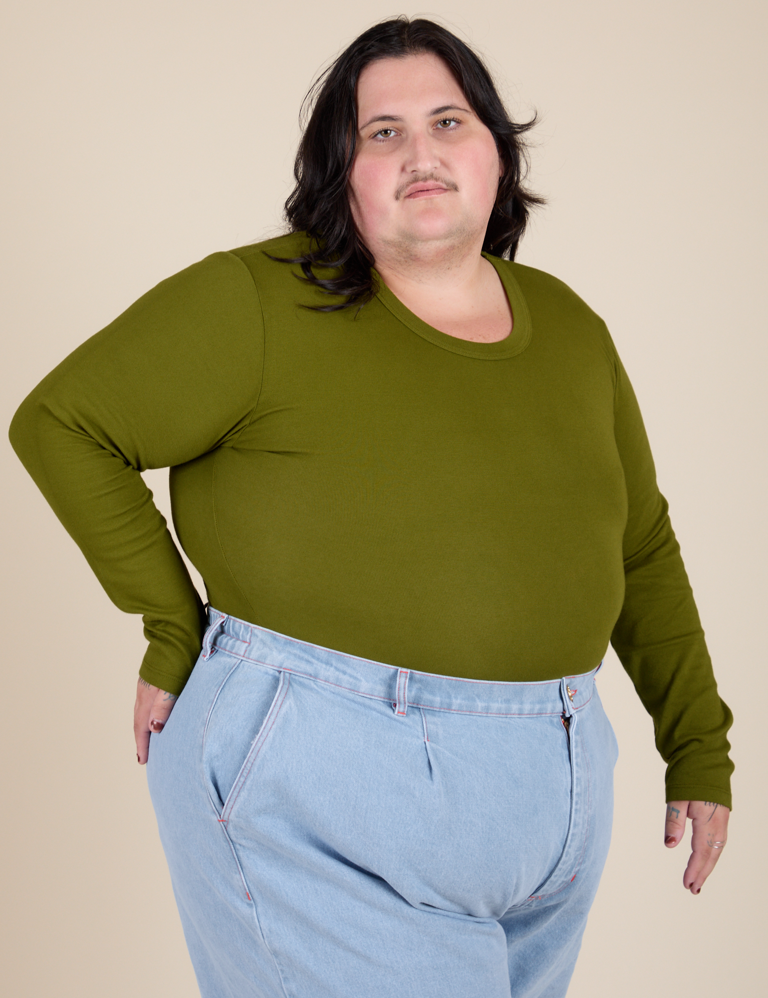 Angled front view of Long Sleeve Baby Tee in Summer Olive on Sam