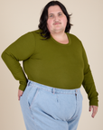 Angled front view of Long Sleeve Baby Tee in Summer Olive on Sam