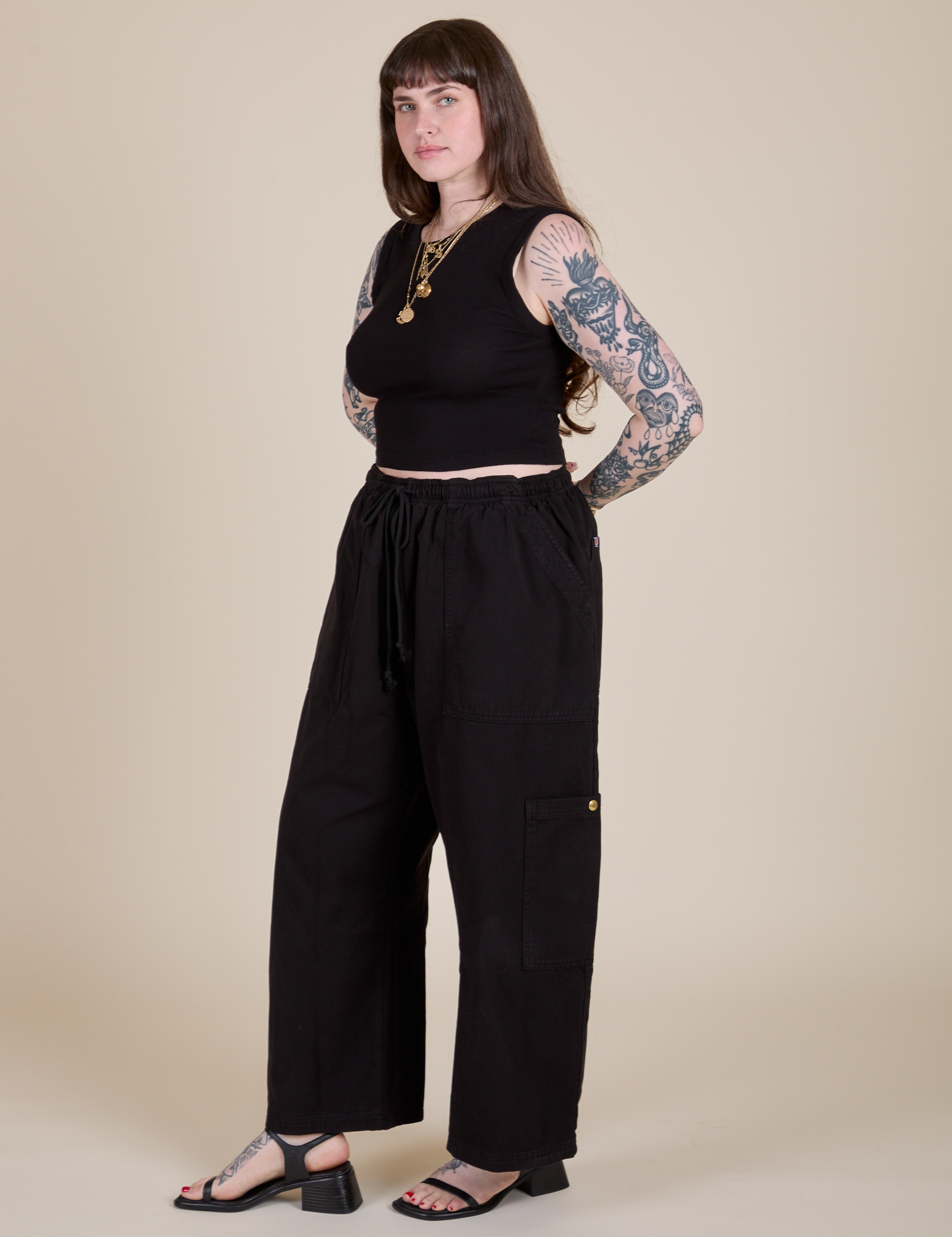 Angled front view of Muscle Tee in Basic Black and black Drop Pocket Cargo Pants on Sydney