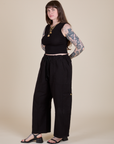 Angled front view of Muscle Tee in Basic Black and black Drop Pocket Cargo Pants on Sydney