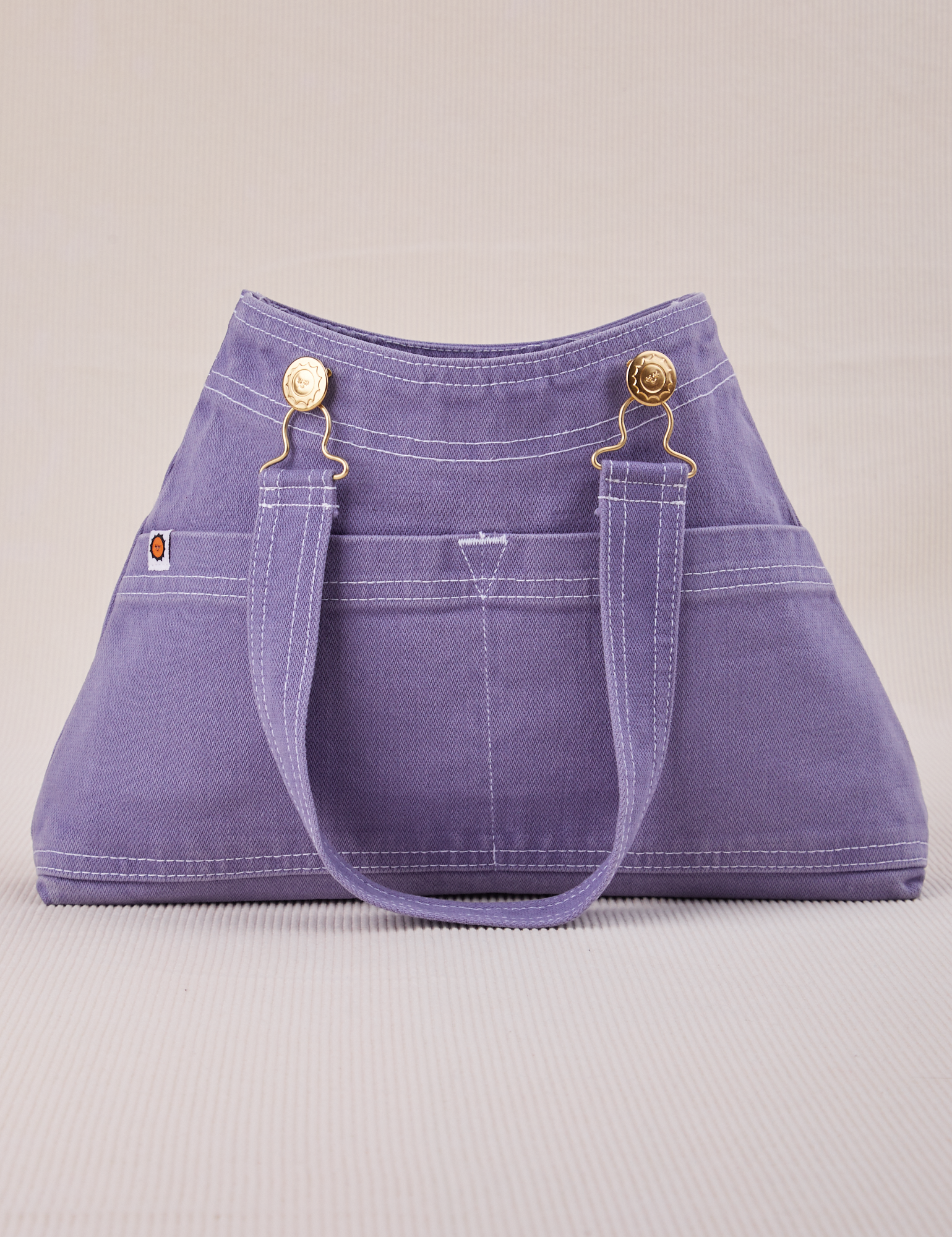 Overall Handbag in Faded Grape with handle strap down