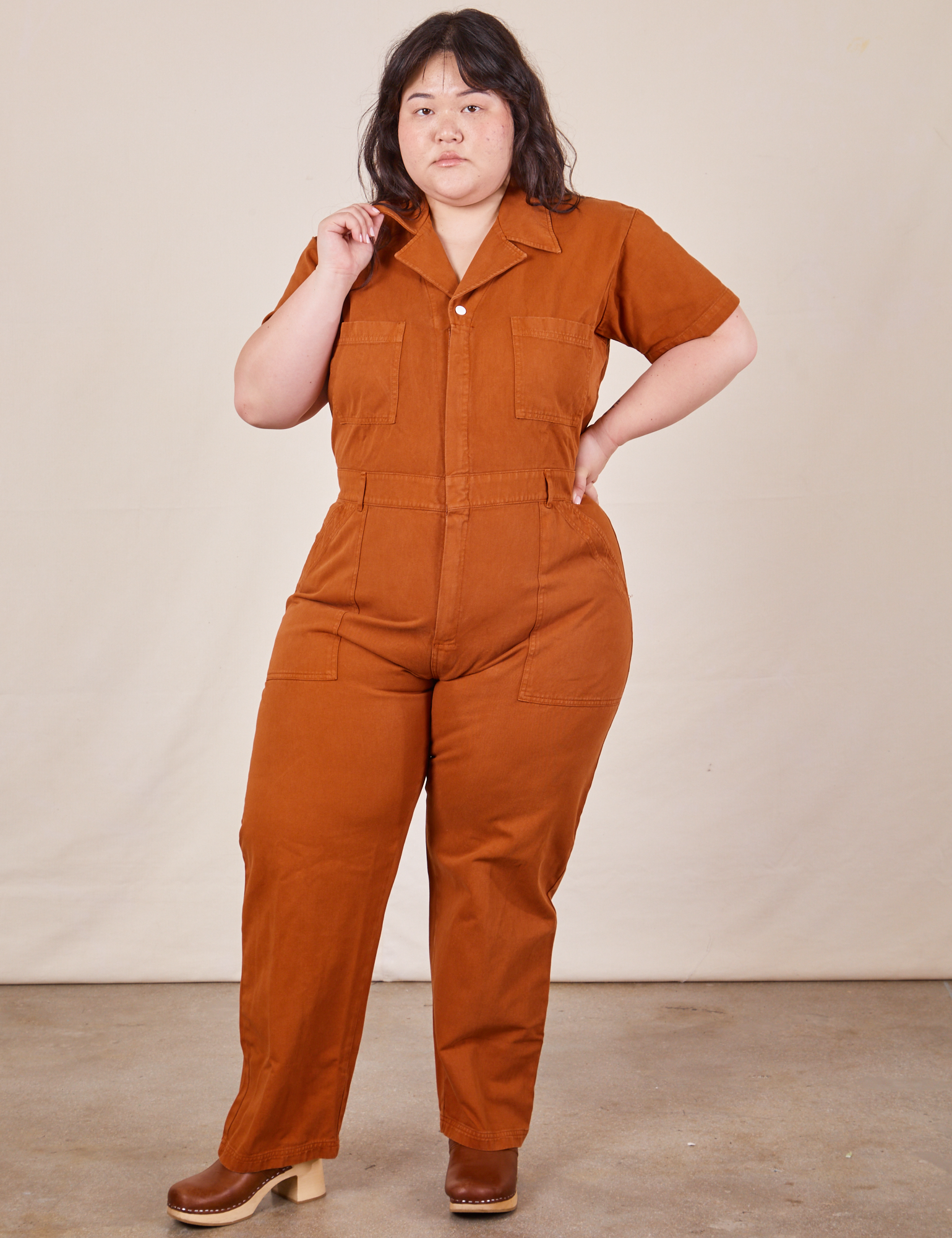Ashley is 5'7" and wearing 1XL Short Sleeve Jumpsuit in Burnt Terracotta 
