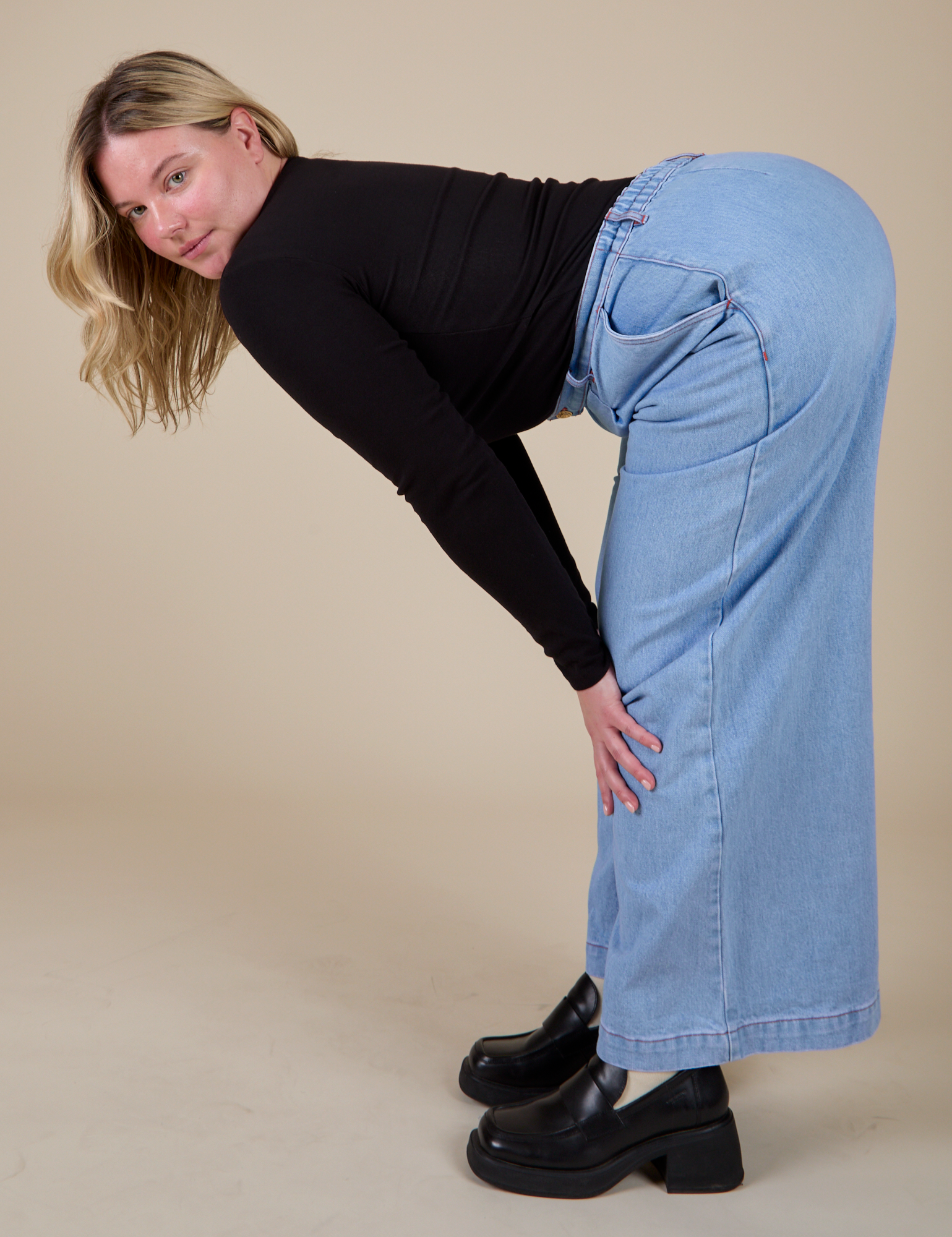 Side view of Long Sleeve Baby Tee in Basic Black and light wash Wide Leg Trousers