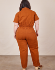 Back view of Short Sleeve Jumpsuit in Burnt Terracotta worn by Ashley