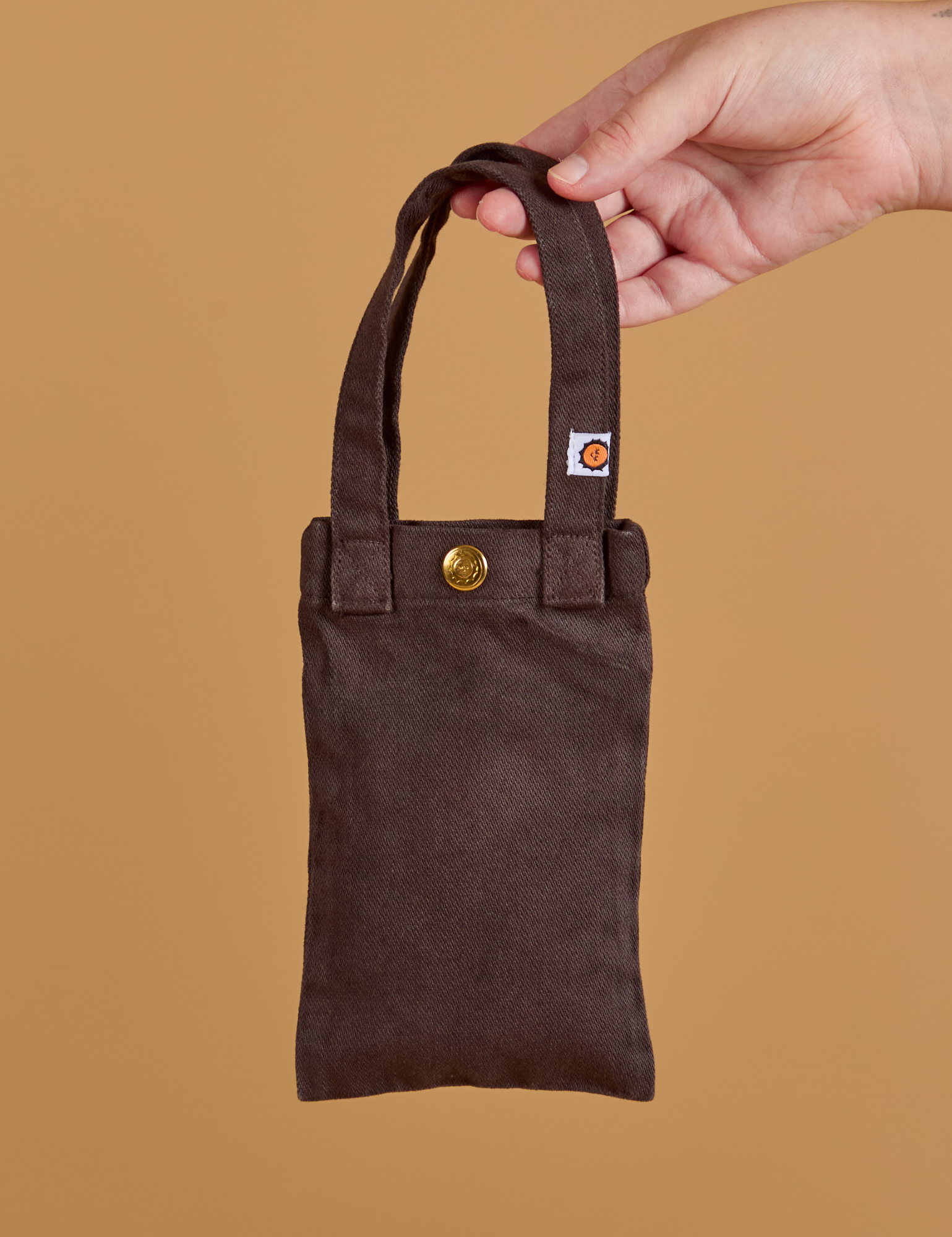 Cell Phone Tote in Espresso Brown held by model