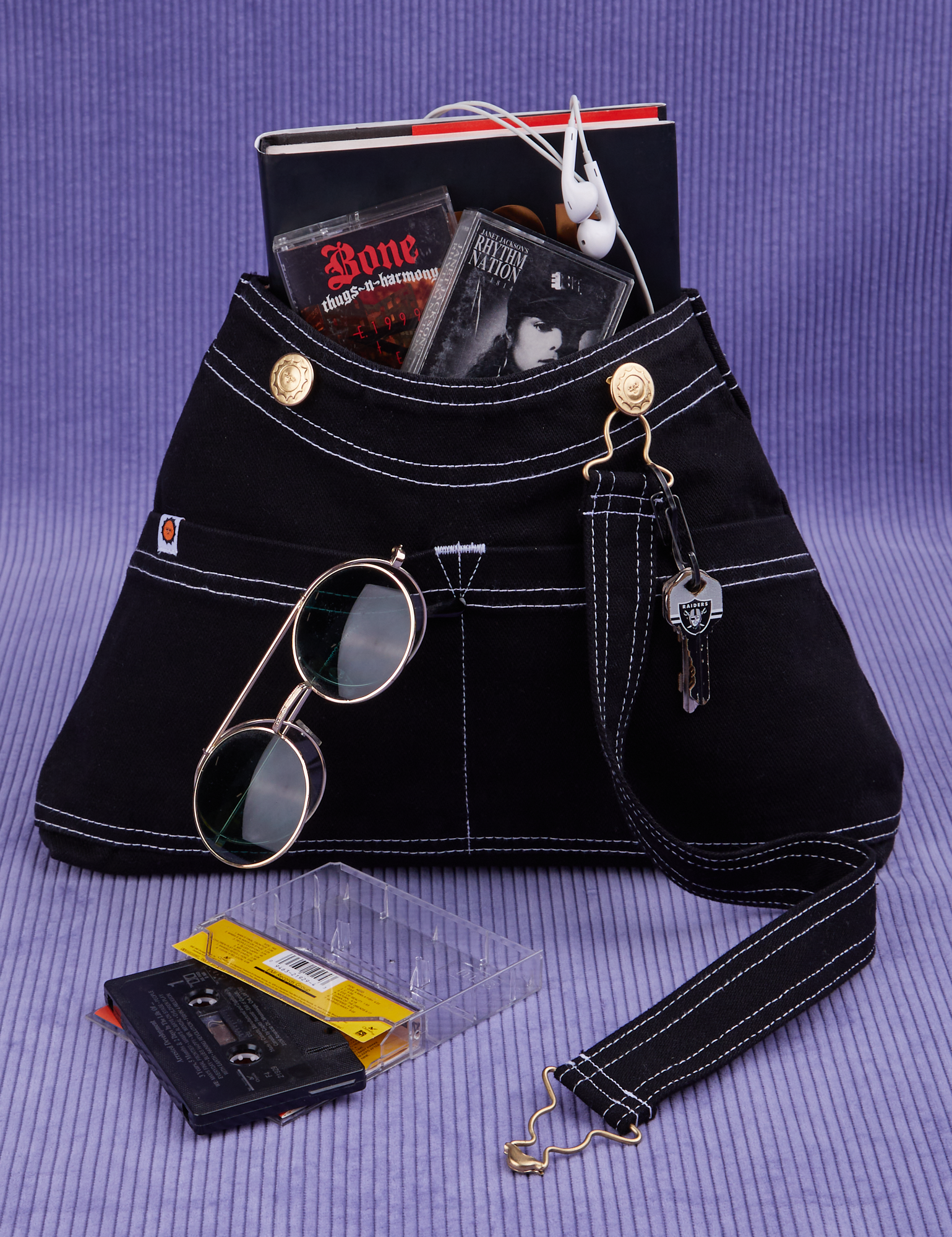 Overall Handbag in Black with book and two cassette tapes in main compartment.
