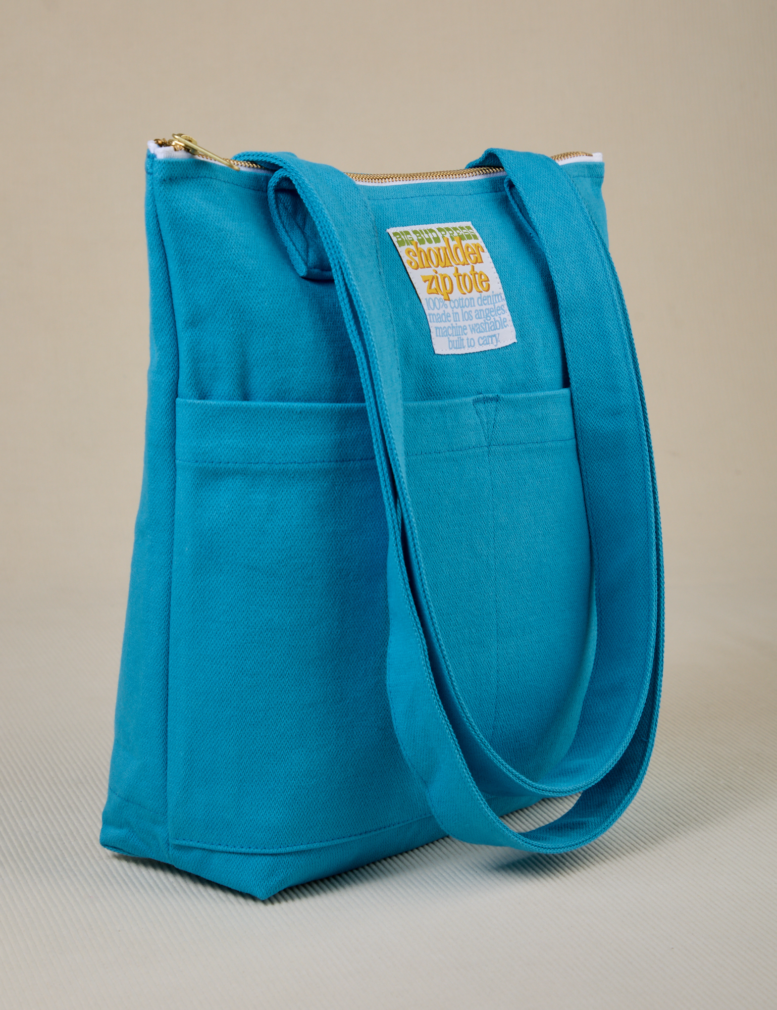 Angled view of Over-Shoulder Zip Mini Tote in Hawaiian Blue