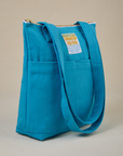 Angled view of Over-Shoulder Zip Mini Tote in Hawaiian Blue