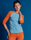 Alex is 5'8" and wearing P Baby Blue/Orange Colorblock Raglan Tee