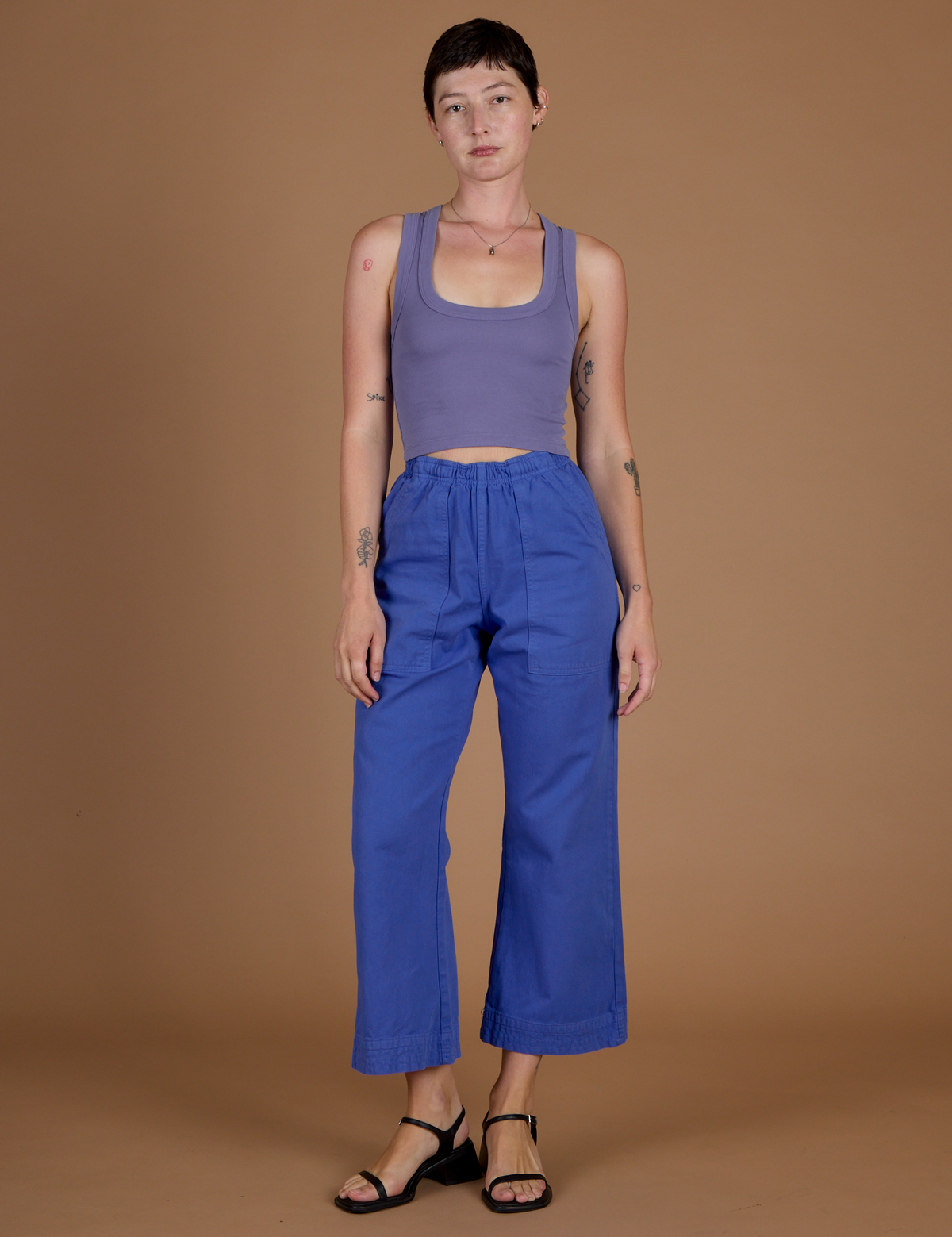 Alex 5'8" and wearing XXS Cornflower Blue Action Pant with the Faded Grape Cropped Tank