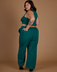 Angled back view of the Hunter Green Action Pant