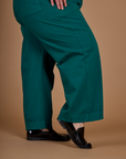 Side view close up of the Hunter Green Action Pant on Kristen