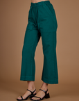 Angled side view of Alex in the the Hunter Green Action Pant