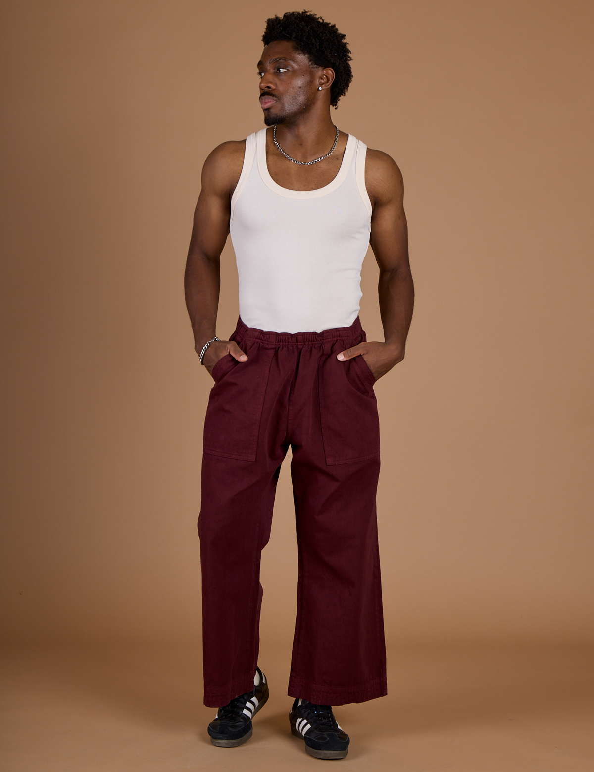 Issac wearing the Red Wine Action Pant with the Vintage Tee Off-White Tank Top