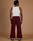 Back view of Isaac in the Red Wine Action Pant