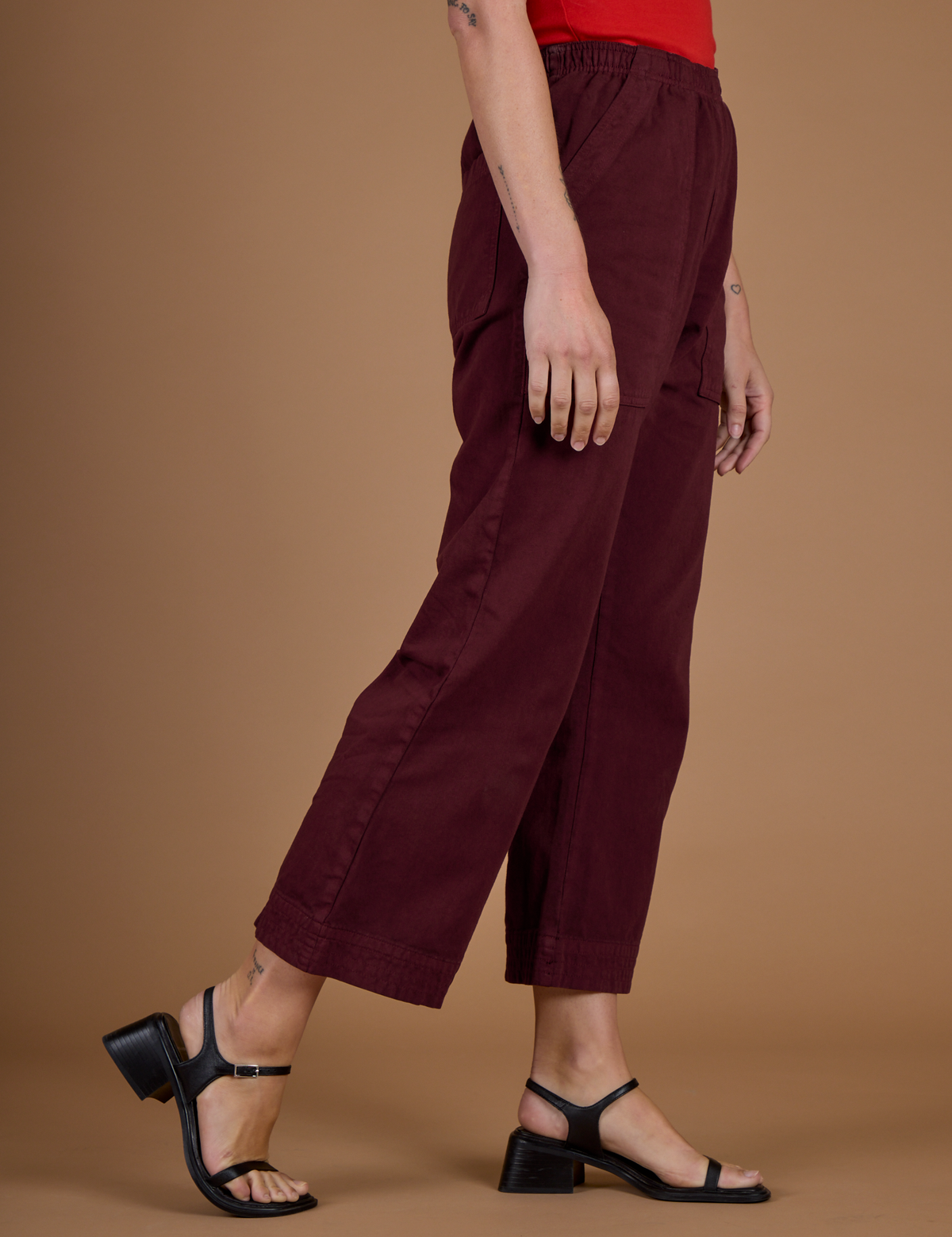 Side view of the Red Wine Action Pant on Alex