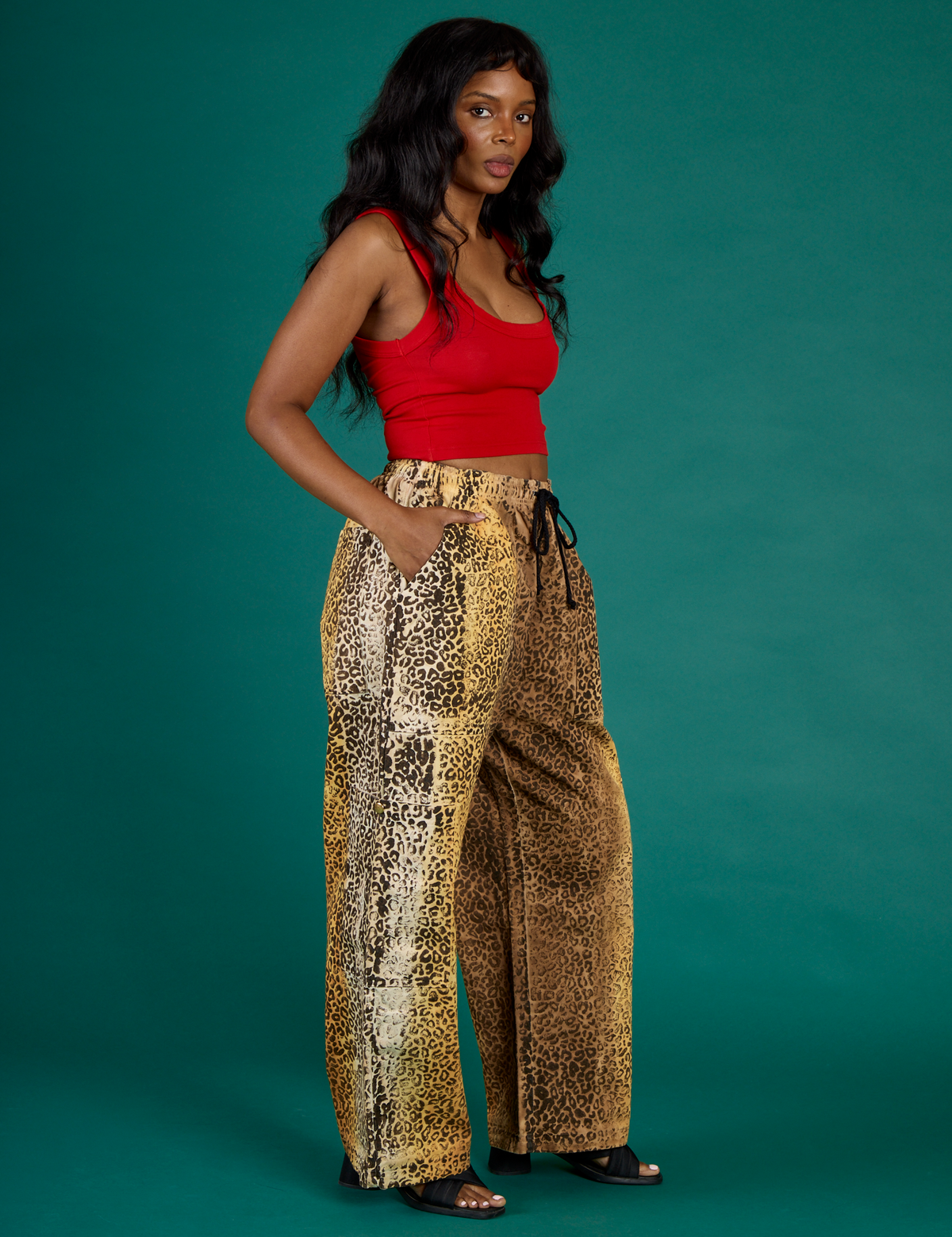Angled side view of Kandia wearing the Leopard Drop Pocket Pant