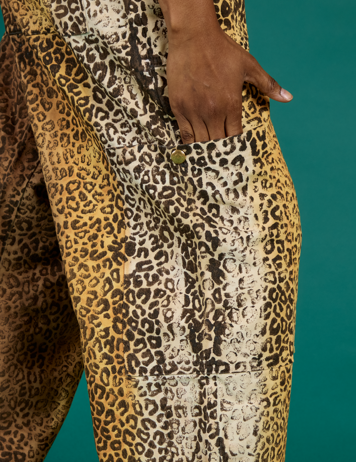 Close up of Kandia's hand in the side leg pocket of the Leopard Drop Pocket Pant
