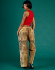 Angled back view of Kira wearing the Leopard Drop Pocket Pant