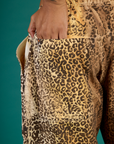 Close up of Kira's hand in the back pocket of the Leopard Drop Pocket Pant