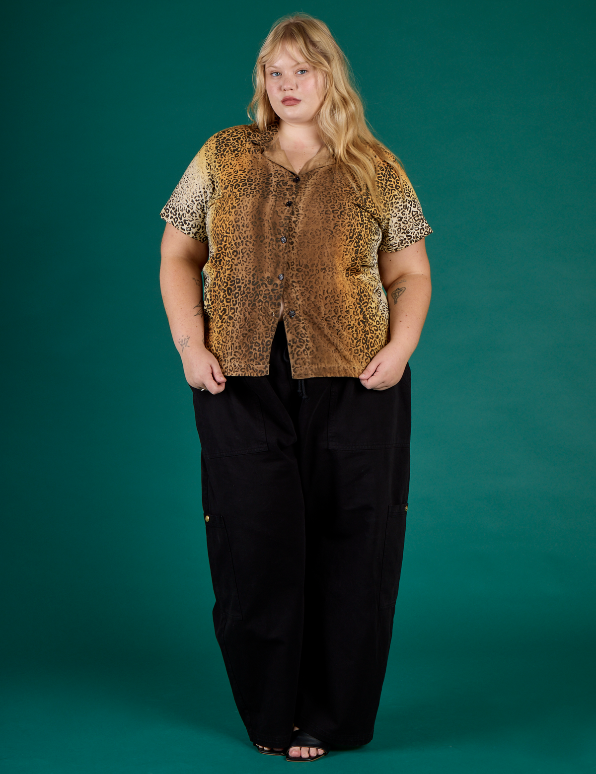 Juliet is wearing the Leopard Pantry Button Up with Black Drop Pocket Cargo Pants