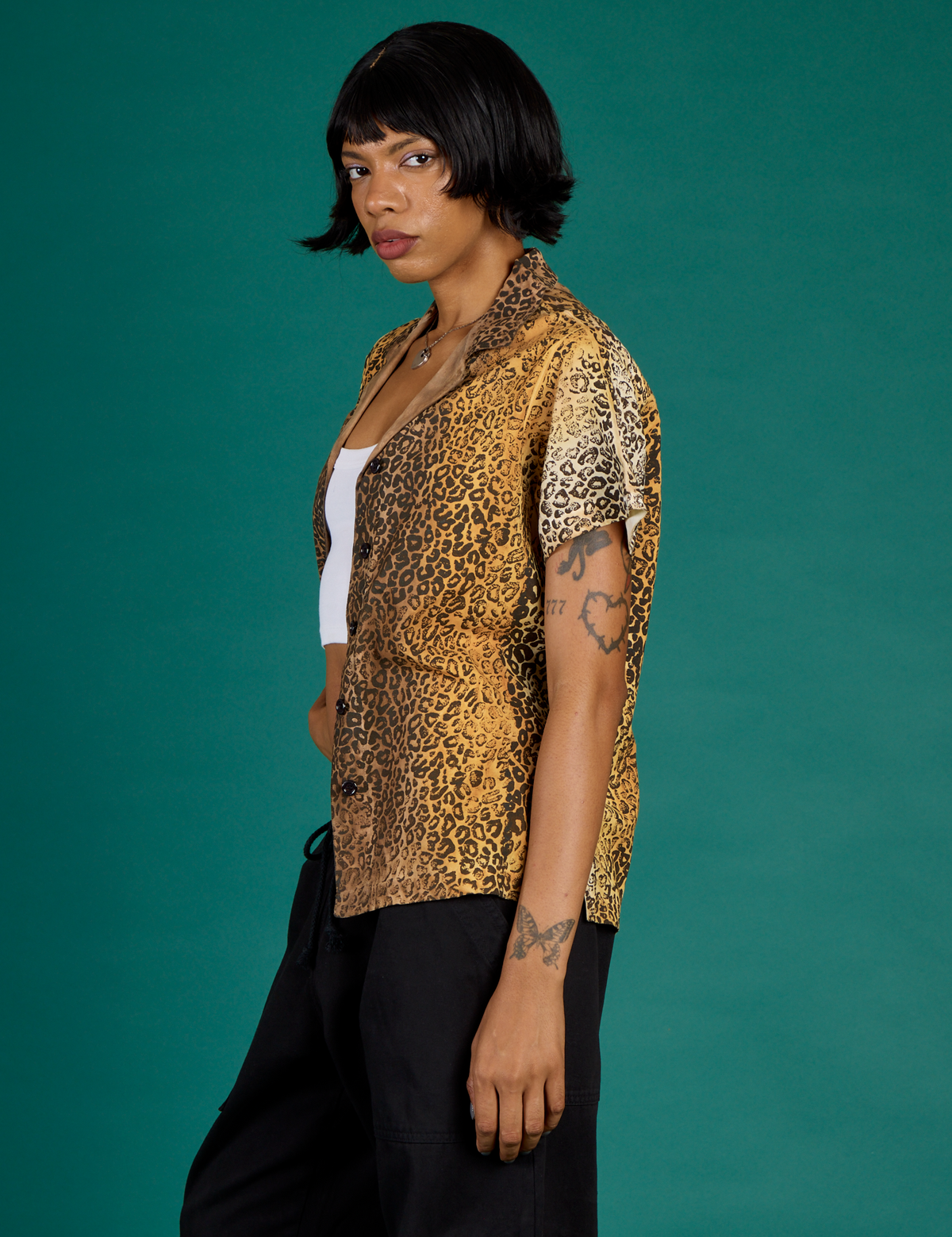 Angled side view of the Leopard Pantry Button Up on Kira