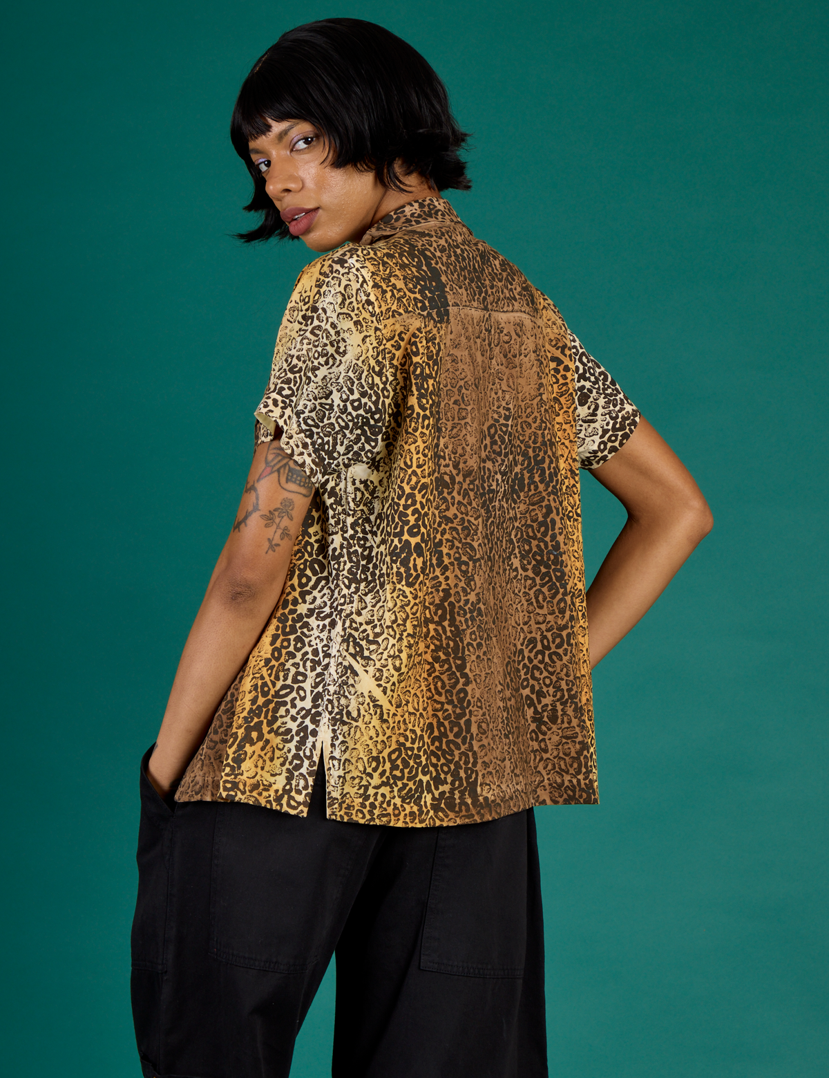 Angled back view of the Leopard Pantry Button Up on Kira