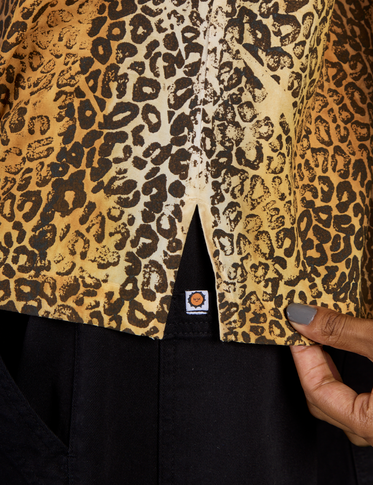 Close up of the side vent of the Leopard Pantry Button Up on Kira