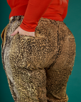 Close up of Juliet's hand in the back pocket of the Leopard Work Pant