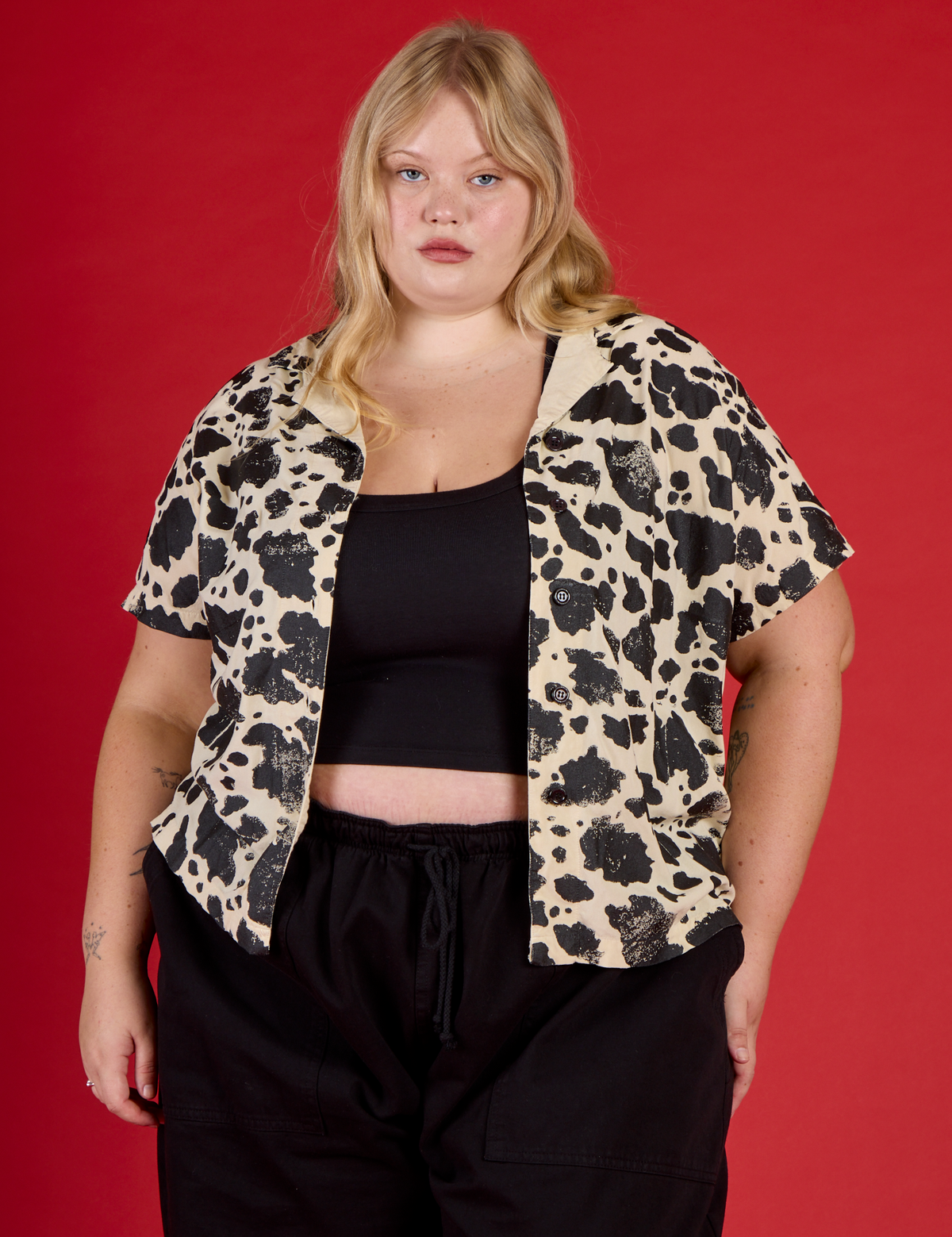 Juliet wearing the Cow Pantry Button Up open with the Black Cropped tank