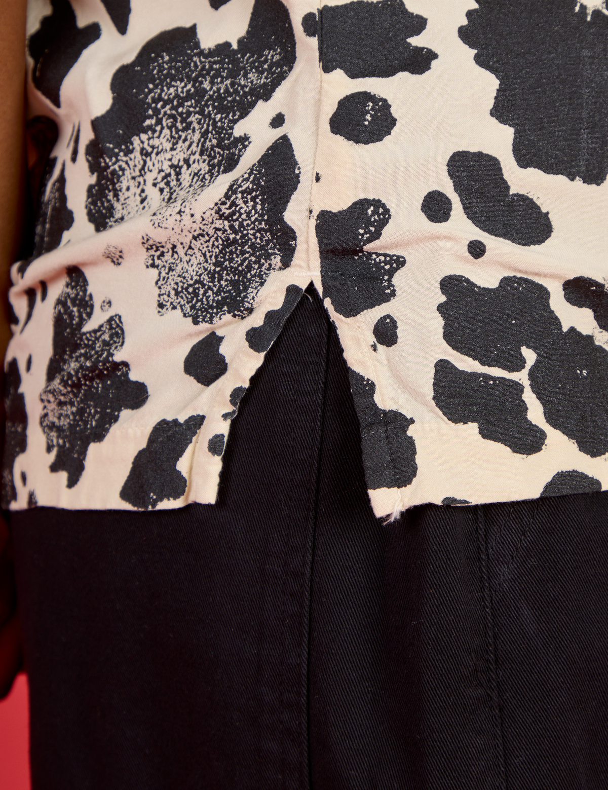 Close up of the side vent of the Cow Pantry Button Up worn by Kira
